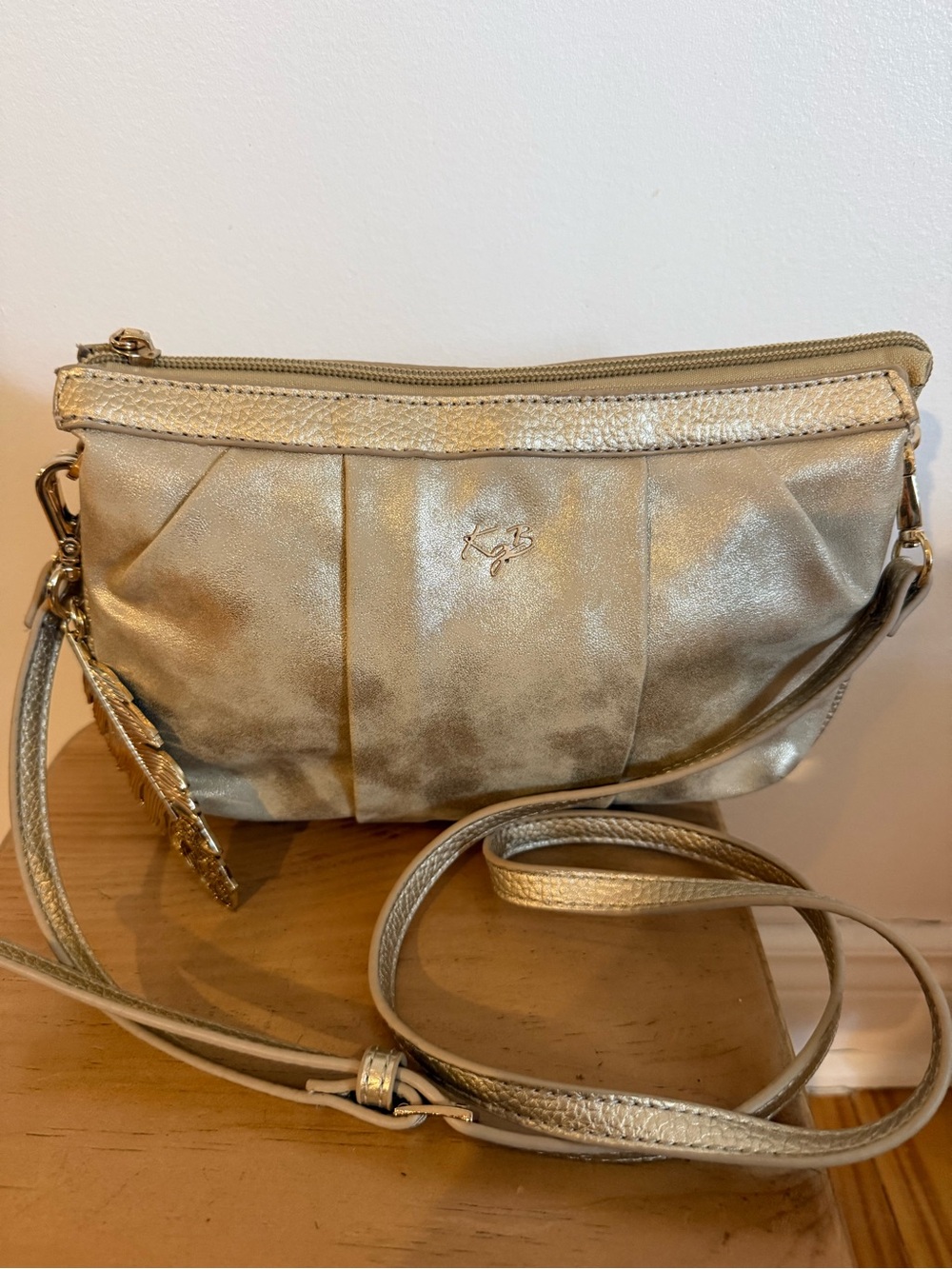 KGB Studio Metallic Gold Crossbody Bag with Feather Charm